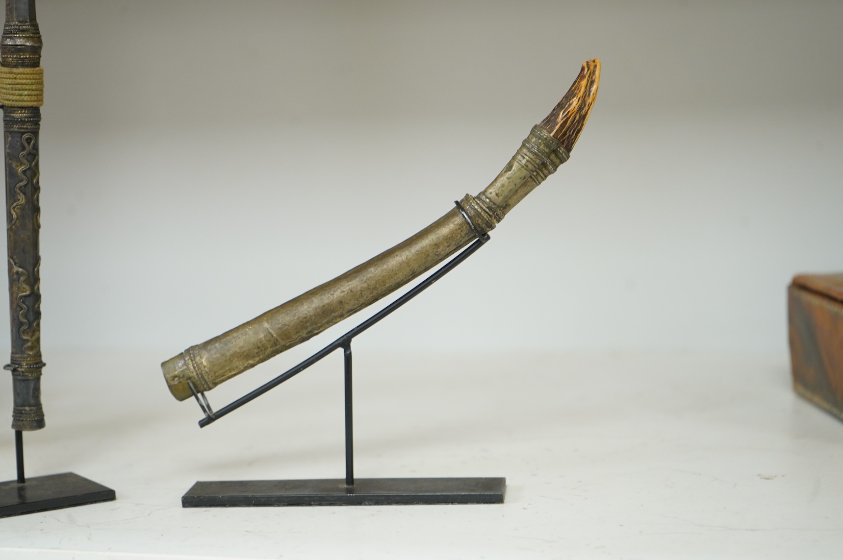 A Burmese dagger dha, blade 14.5cm, hilt and sheath covered in sheet silver filigree decoration, together with an unusual pair of small Burmese knives with silver mounted stag horn handles and silver covered sheath, both